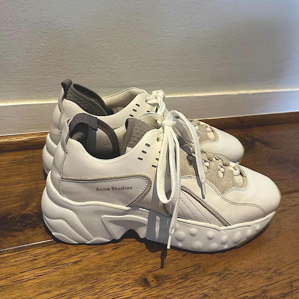 These are acne studio women sneakers in white and grey accents.